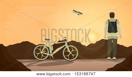Futuristic illustration. Man standing and looking at mountains and at sun. Man traveling by bicycle with drone.