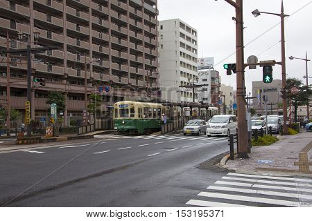 Nagasaki, Japan - August 19, 2015 Cars And Vintage Tram On The Road