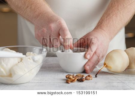 Man Preparing Ingredients For Cooking Sauce Using Mortar And Pestle