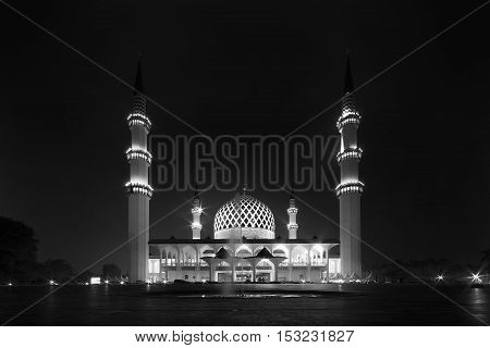 View of Shah Alam Mosque during night time in black and white.