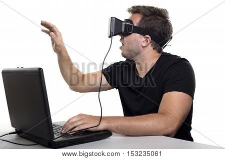 Virtual Reality gamer wearing headset tethered to a gaming pc