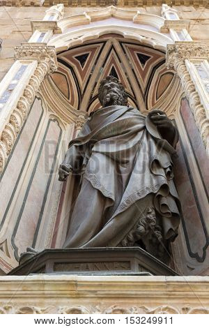 FLORENCE, ITALY - SEPTEMBER 2016 : Bronze statue of St. John the Baptist, detail of Orsanmichele church exterior with 1of 14 external niche figures in Florence, Italy on September 21, 2016. 