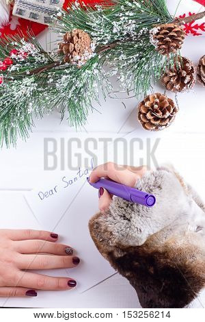 woman hands writing on christmas postcard closeup hands