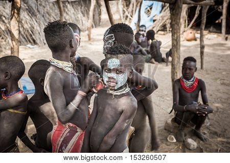 Kolcho Ethiopia - 18 August 2016: two unidentified boys from Karo tribe paint their face with natural colors and stick