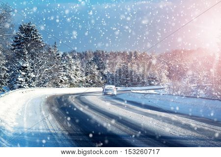 Car tires on winter road covered with snow