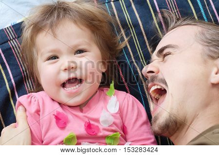 Happy kid and daddy having fun laughting very emotional