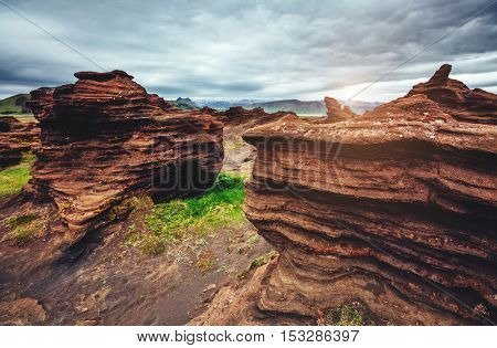 Sandy rocks with by magma formed by winds. Popular tourist attraction. Unusual and gorgeous scene. Location Sudurland, cape Dyrholaey, south coast of Iceland, Europe. Artistic picture. Beauty world.