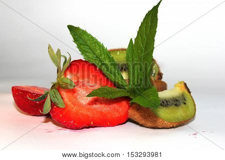 composition with strawberries, kiwi, mint on a white background