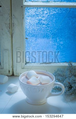 Sweet and hot chocolate with marshmallows for Christmas at cold night
