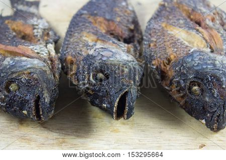 Three fish body  fry on Chopping Wood and asian food.