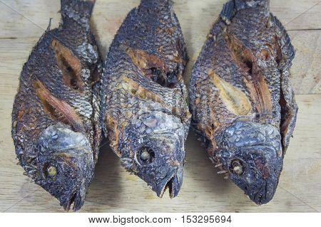 Three fish body fry on Chopping Wood and asian food.
