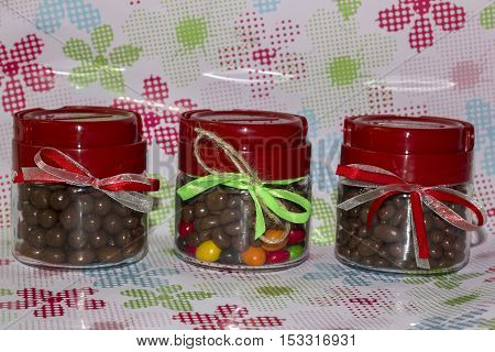 Three glass jars with ribbons and candy