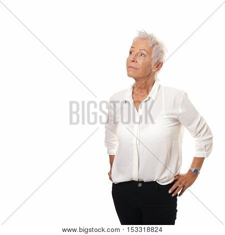 thoughtful older woman looking up at copy space