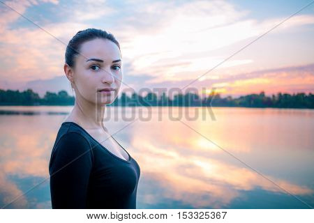 Young Woman Portrait In Morning At Colorful Sunrise Background