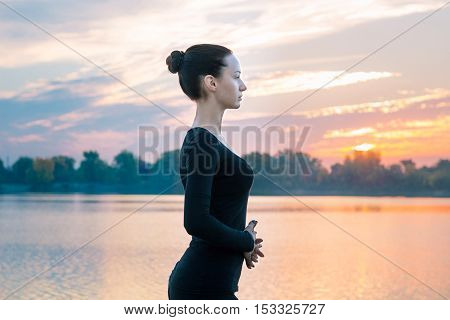 Young Woman Portrait In Early Morning During Colorful Sunrise