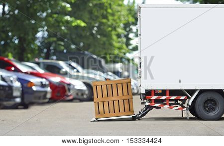 transportation and logistics concept - Delivery truck parking to delivery parcel wood box with wood wall and copyspace