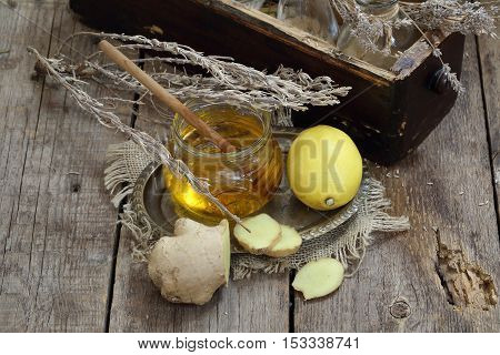Still life with gingerlemonhoney and Provencal herbs on a wooden table