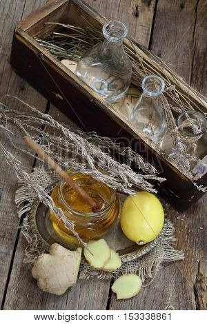 Still life with gingerlemonhoney and Provencal herbs on a wooden table