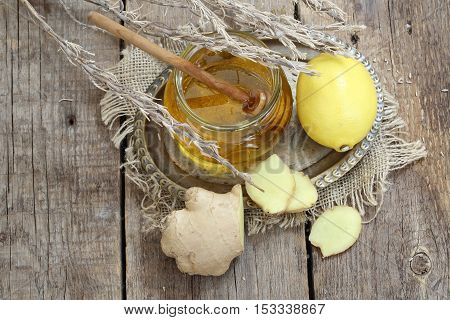 Still life with gingerlemonhoney and Provencal herbs on a wooden table