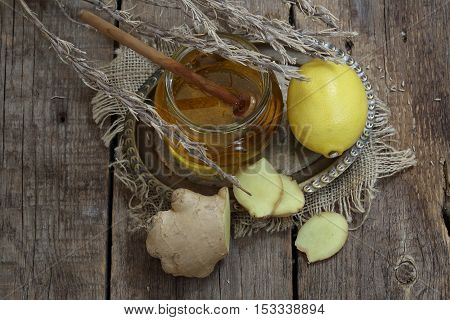Still life with gingerlemonhoney and Provencal herbs on a wooden table