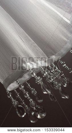 Closeup on the part of the white curtainsider with dangling crystals