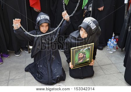 Istanbul Turkey - October 11 2016: Children takes part in an Ashura ceremony. Turkish Shia Muslims mourning for Imam Hussain. Caferis take part in a mourning procession marking the day of Ashura in Istanbul's Kucukcekmece district Turkey on October 11 201
