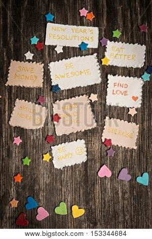 New Year Goals Or Resolutions With Decorations On Rustic Wooden Background