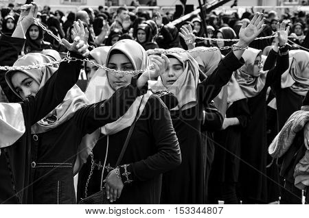 Istanbul Turkey - October 11 2016: Shia Muslim women shout Islamic slogans as they mourn during an Ashura procession. Turkish Shia Muslims mourning for Imam Hussain. Caferis take part in a mourning procession marking the day of Ashura in Istanbul's Kucukc