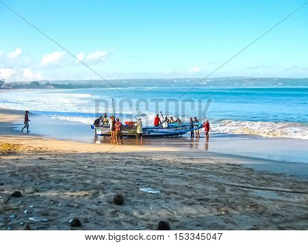 Jimbaran Bali Indonesia - April 20 2012: The loacal fishermen with fish boat at Jimbaran Beach Bali Indonesia