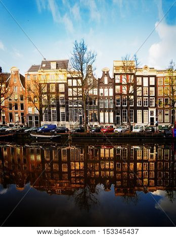 Facades of dutch houses over canal with mirror reflections, Amstardam, Netherlands, retro toned
