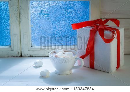 Tasty chocolate with marshmallows for Christmas on old white table