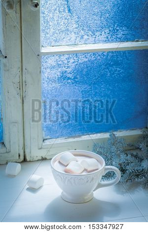 Sweet Christmas chocolate with marshmallows on old white table