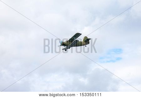 SAMARA RUSSIA - SEPTEMBER 11 2016: The Antonov An-2 is a Soviet mass-produced single-engine biplane in flying against cloudy sky