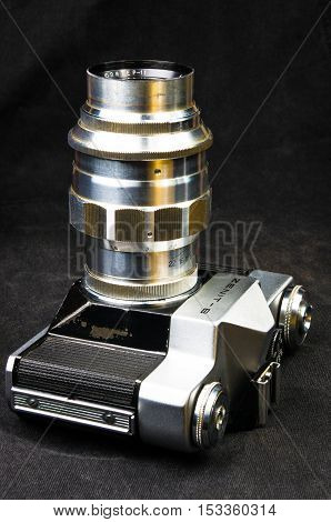 DONETSK, UKRAINE - May 07, 2016: old soviet film SLR camera Zenit - B with lens Jupiter-11, for use with 35 mm film, made in USSR in 1968 - 1973, manufactured by KMZ, with original leather case