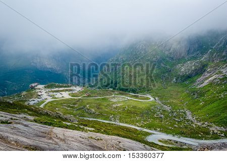 Mountain serpentine roads and parking at the start of touristic hiking path to famous Kjerag stone. Norway, Lysefjord