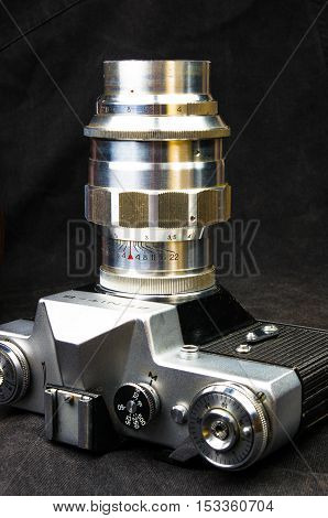 DONETSK, UKRAINE - May 07, 2016: old soviet film SLR camera Zenit - B with lens Jupiter-11, for use with 35 mm film, made in USSR in 1968 - 1973, manufactured by KMZ, with original leather case