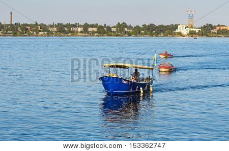 DNEPR UKRAINE - SEPTEMBER 10 2016:Motor boats with passengers running between banks of Dnepr river during City Day local activity in Dnepr, Ukraine at September 10, 2016