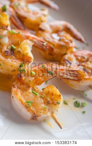 Fresh hot grilled jumbo shrimp kebabs with parsley