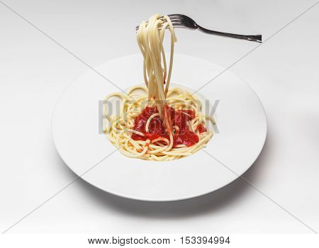 dish with spaghetti shot like emoji on white