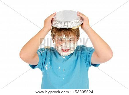 Funny Eleven Year Old Boy with a Cream Pie on top of his head.  He has whipped cream all over his face
