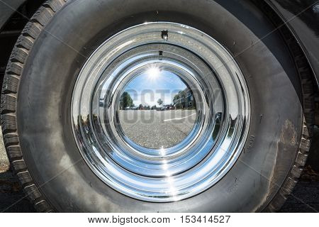 Mirrored chrome cover of vintage car wheel