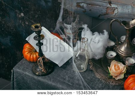 Still life with halloween pumpkin. gloomy style. candles cobwebs