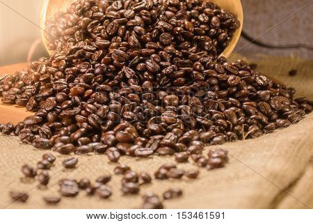 Coffee beans in wood plate place on hemp sack