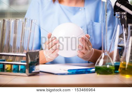 Doctor in lab with crystall ball