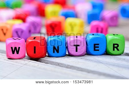 Winter word on gray  wooden table closeup