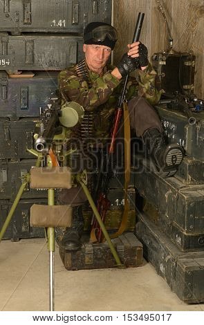 Portrait of armed combat soldier in ammunition