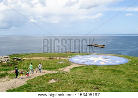 LA CORUNA SPAIN - May 28 2016: Tourist at the Compass Rose (La Rosa de los Vientos) at the Tower of Hercules in La Coruna Spain.