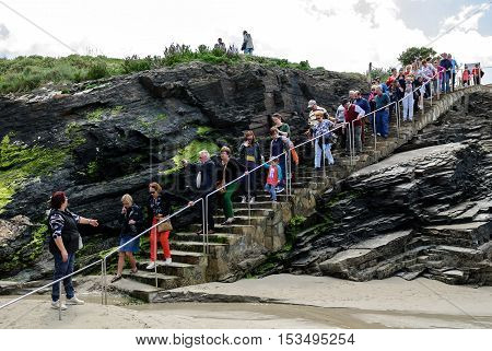 A Coruna Spain - May 29 2016: Turists visiting Cathedrals beach (playa de las catedrales) Spain Atlantic ocean. Famous beach in Northern Spain. Natural rock arch on Cathedrals beach in low tide (Cantabric coast Lugo (Galicia) Spain).