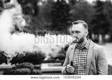Men With Beard Vaping Electronic Cigarette Outdoor