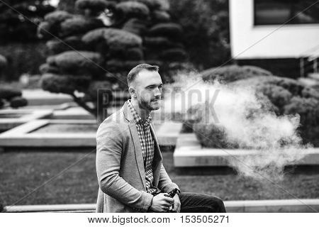 Men With Beard Smoking Electronic Cigarette Outdoor